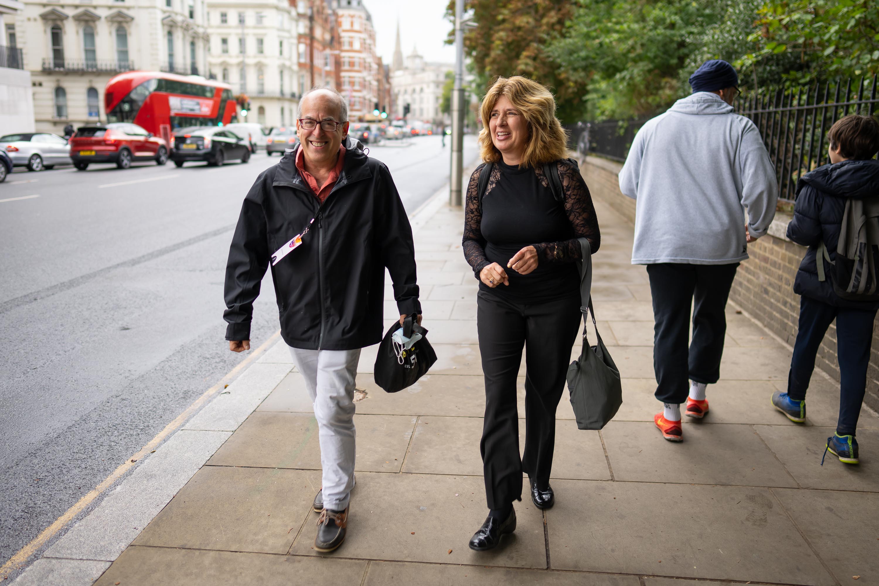 Violinist Paul Arnold and English horn player Elizabeth Masoudnia walk from the hotel to the Royal Albert Hall