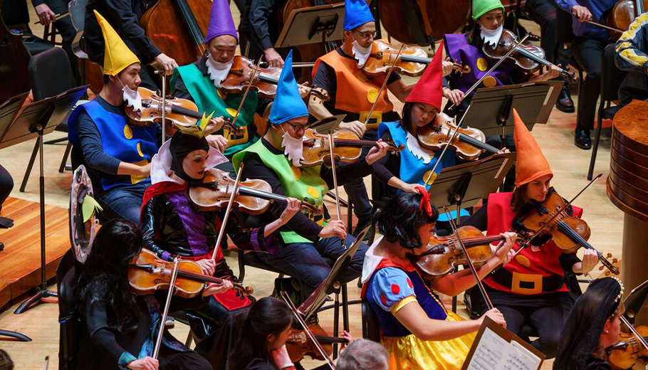 Orchestra musicians playing in costume.